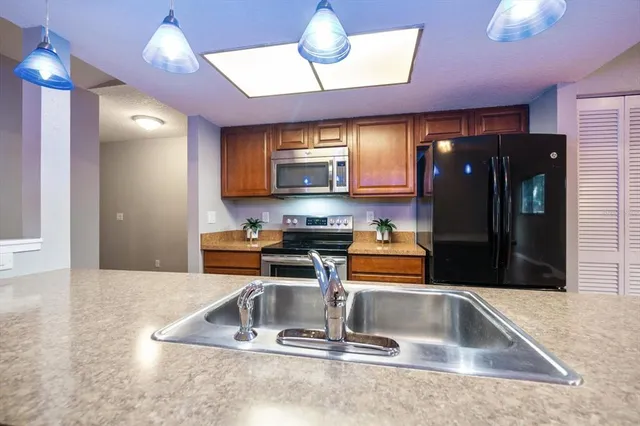 a kitchen with counter top space cabinets and stainless steel appliances