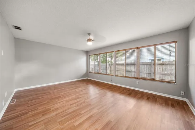 wooden floor in an empty room with a window