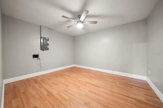 a view of an empty room with wooden floor