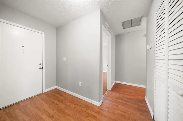 a view of an empty room with wooden floor