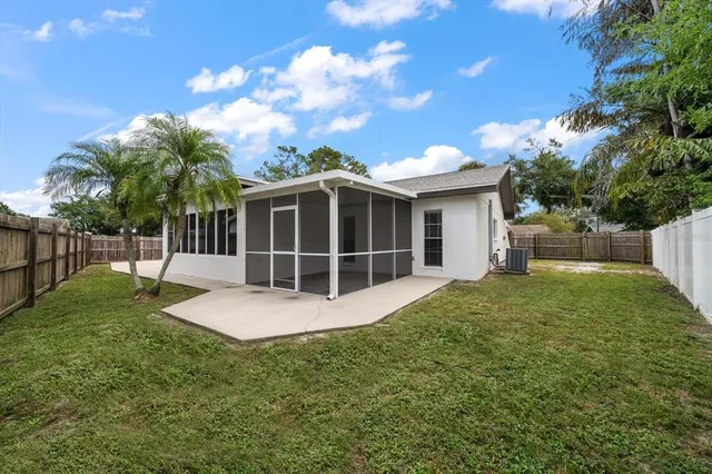 a view of a house with backyard and porch