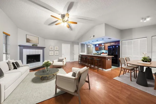 a living room with furniture a fireplace and a flat screen tv