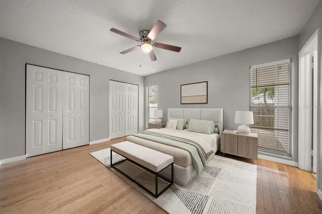a bedroom with a large bed and a chandelier