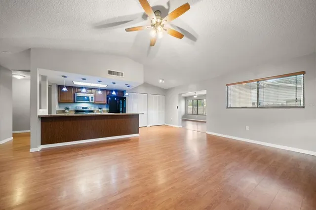 a view of kitchen and hall with wooden floor