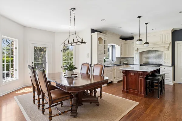 a large kitchen with a table and chairs