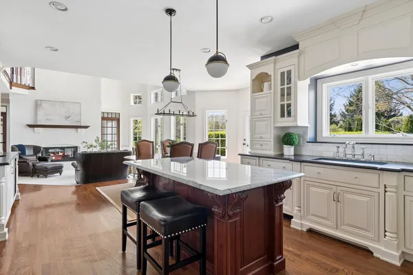 a kitchen with granite countertop white cabinets and a window