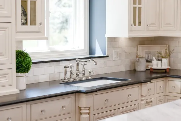a stove top oven sitting inside of a kitchen