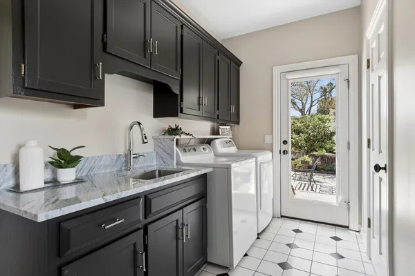 a bathroom with a granite countertop sink a toilet and shower