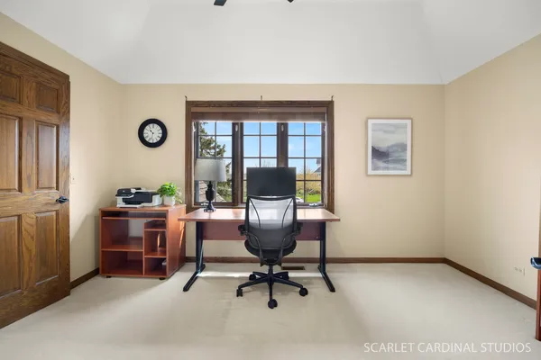 a living room with furniture a rug and kitchen view