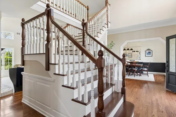 a view of entryway and hall with wooden floor