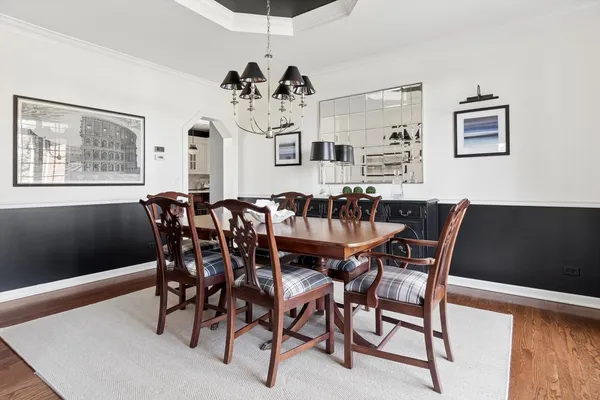 a view of a dining room with furniture and chandelier