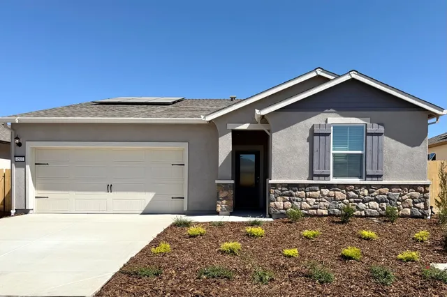 a front view of a house with a garage