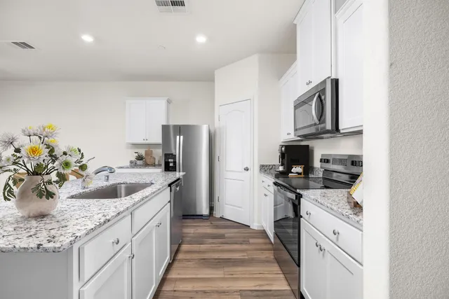 a kitchen with a sink stove and refrigerator