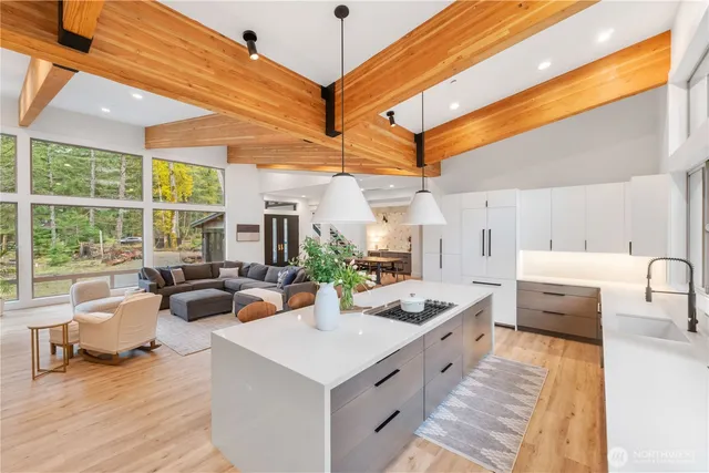 a large white kitchen with a large window