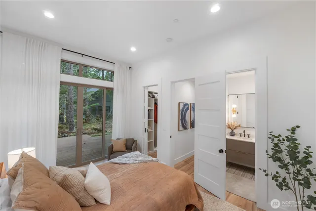 a bedroom with a bed and a large window