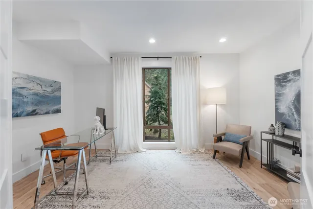 a living room with furniture a flat screen tv and a window