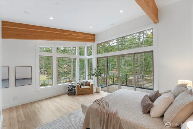 a bed room with a bed and a large window