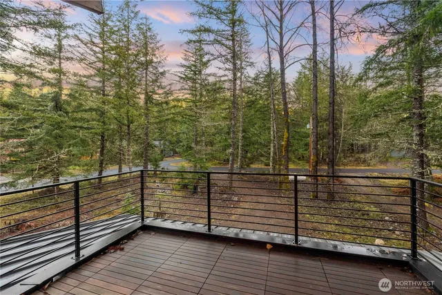 a view of a wooden balcony with an outdoor space