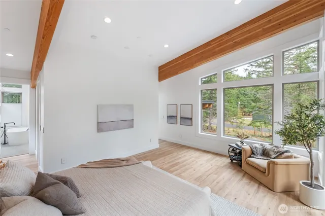 a bedroom with furniture and a large window