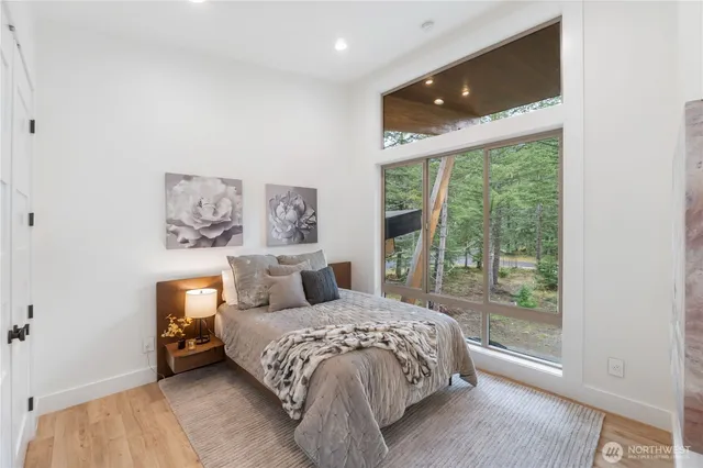 a bedroom with a large bed and a large window