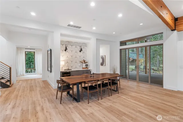 a dining room with furniture a rug and wooden floor