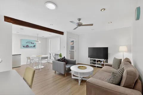 a living room with furniture a rug and a chandelier