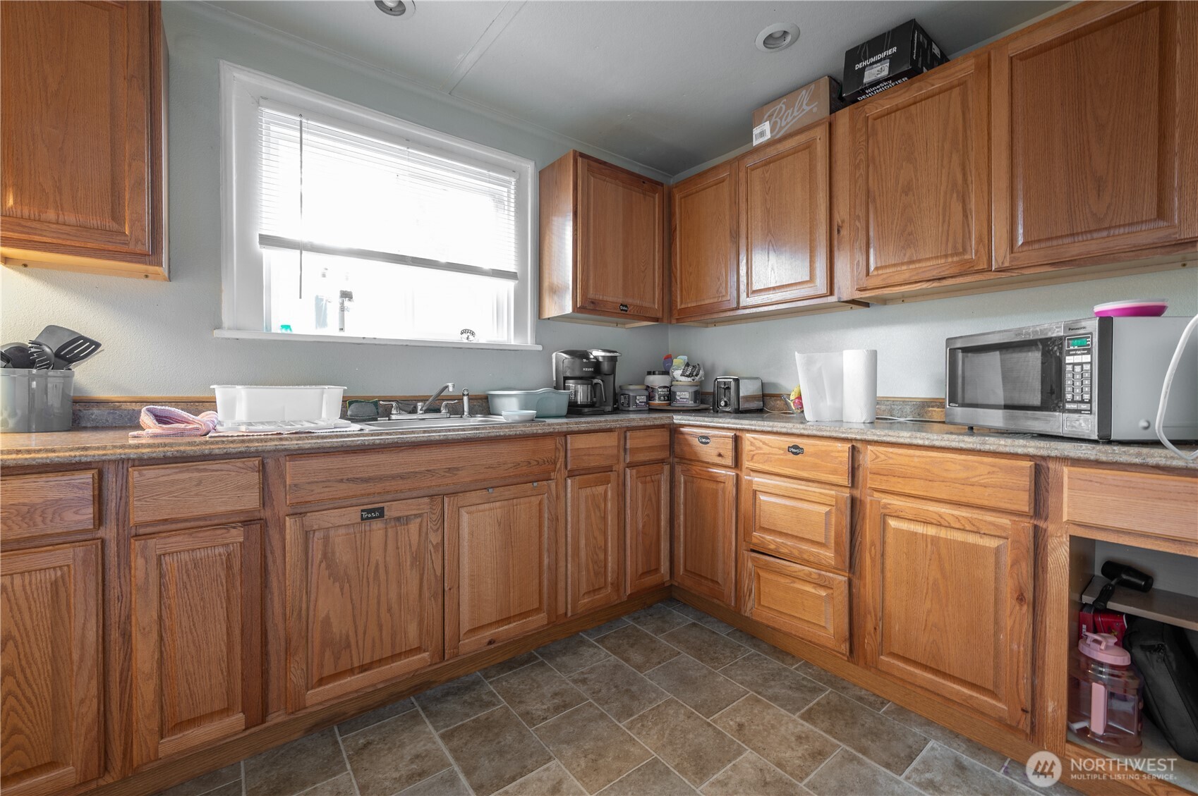 409 North M Street Aberdeen, WA 98520 - Photo 9 of 20 a kitchen with sink cabinets and window