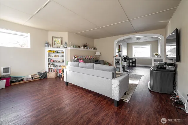a living room with furniture and a wooden floor