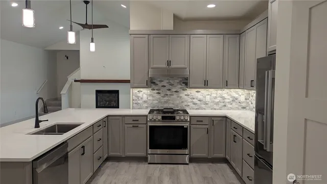 a kitchen with a sink stove and cabinets