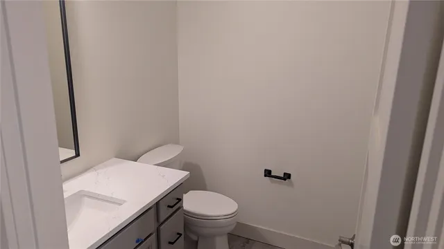 a white toilet sitting next to a shower
