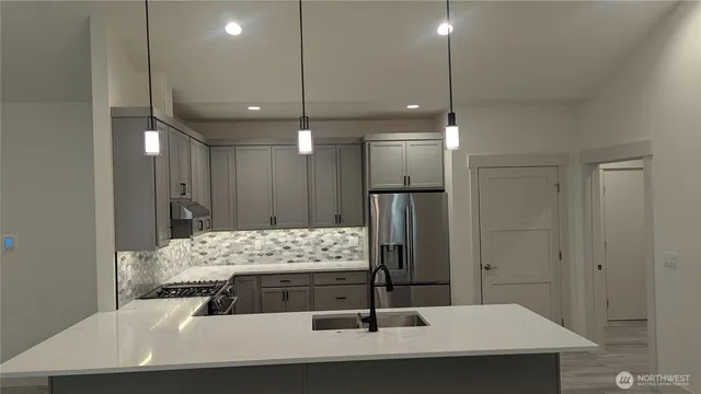 a view of kitchen with refrigerator and window