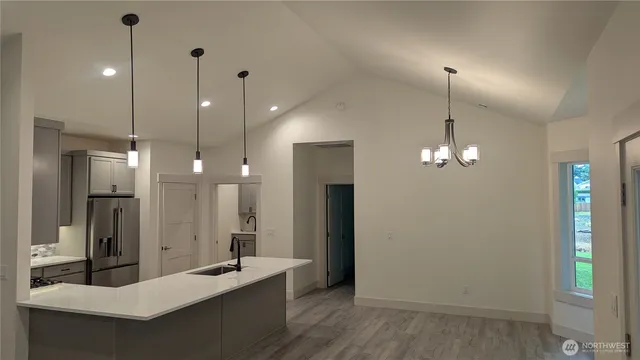 a bathroom with a sink a light fixture and a mirror