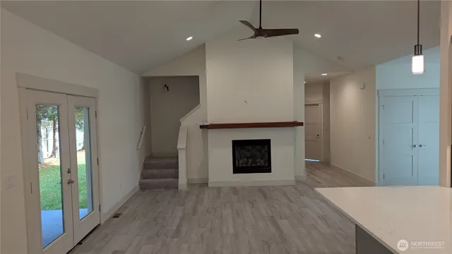 wooden floor in an empty room with a fireplace