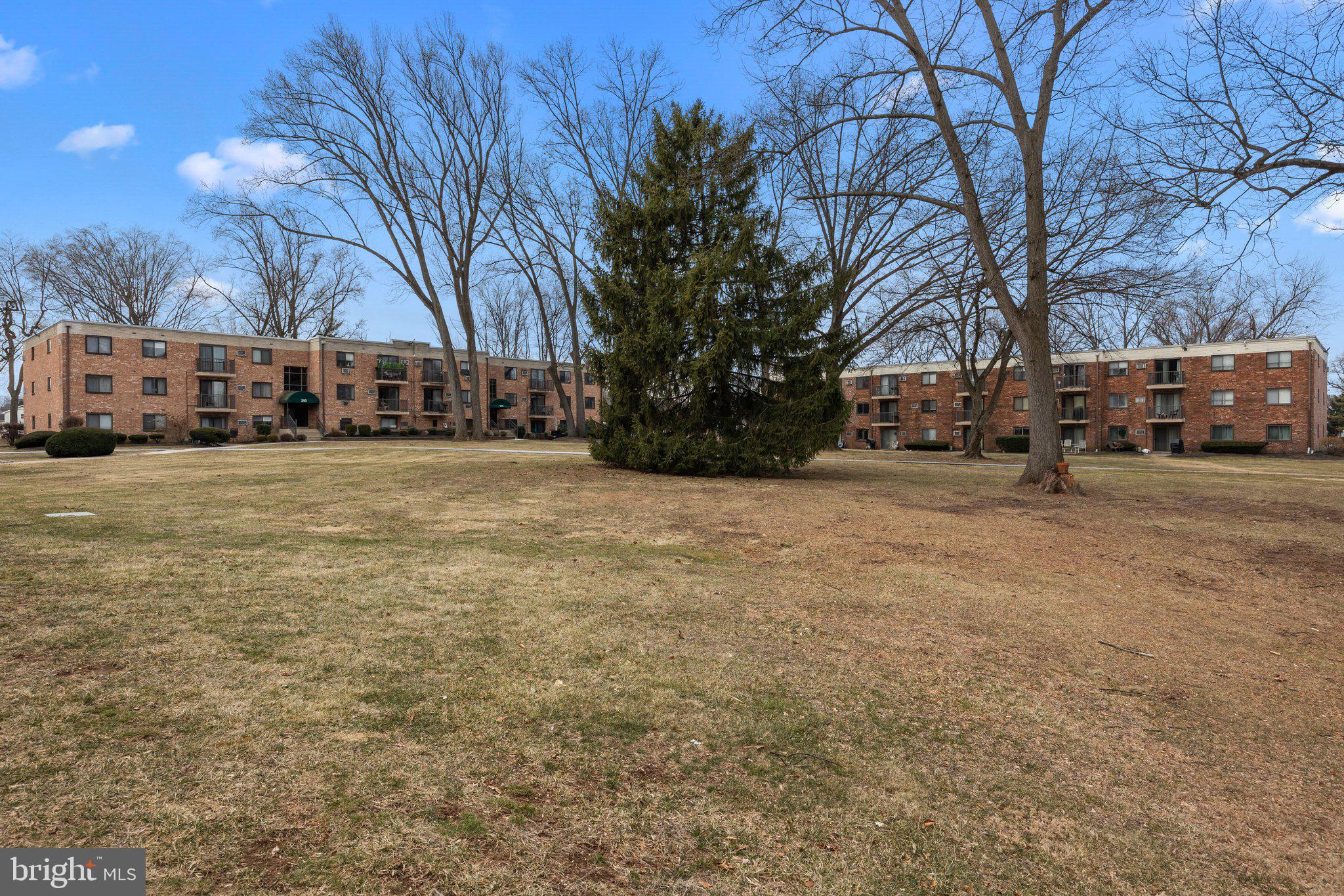 1575 West Street Road, Unit 818 Warminster, PA 18974 - Photo 23 of 24 a tall house with trees in front of it