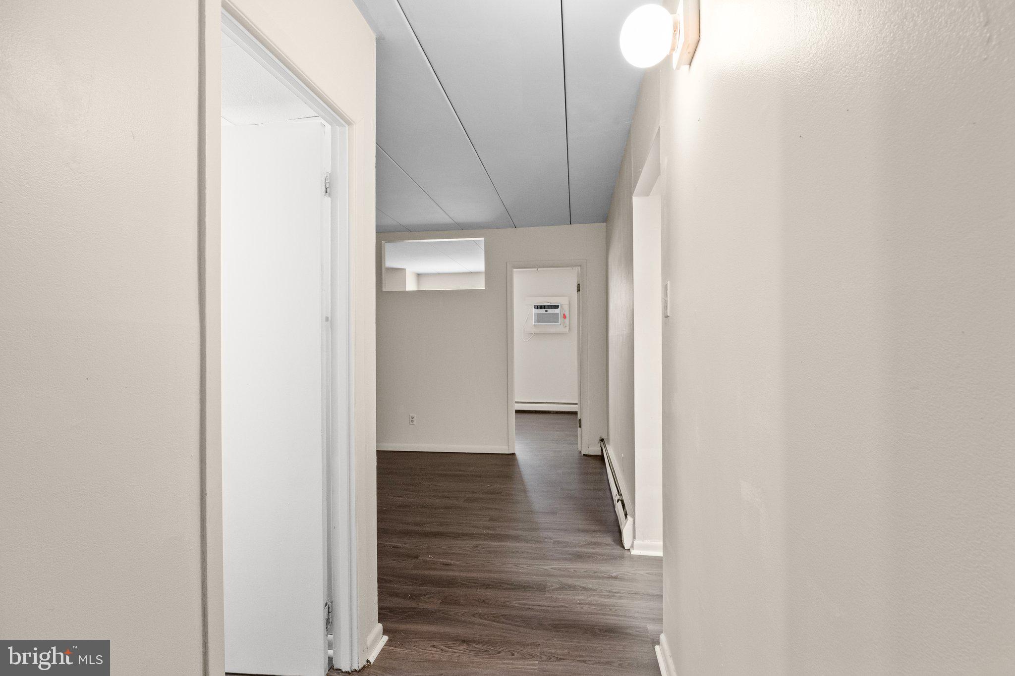 1575 West Street Road, Unit 818 Warminster, PA 18974 - Photo 4 of 24 a view of a hallway with wooden floor