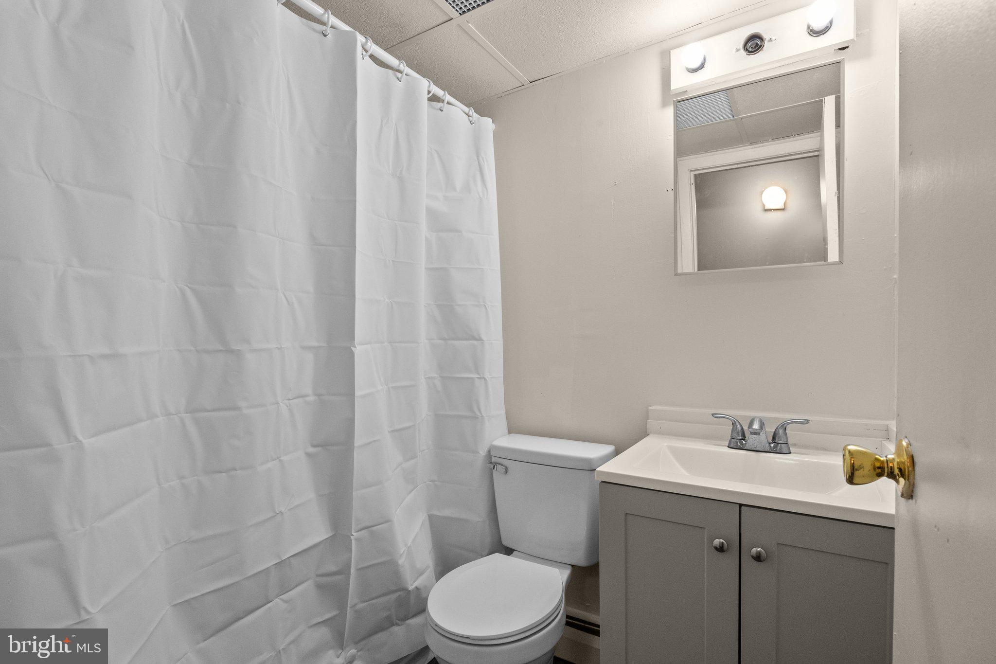 1575 West Street Road, Unit 818 Warminster, PA 18974 - Photo 6 of 24 a bathroom with a sink a toilet and vanity