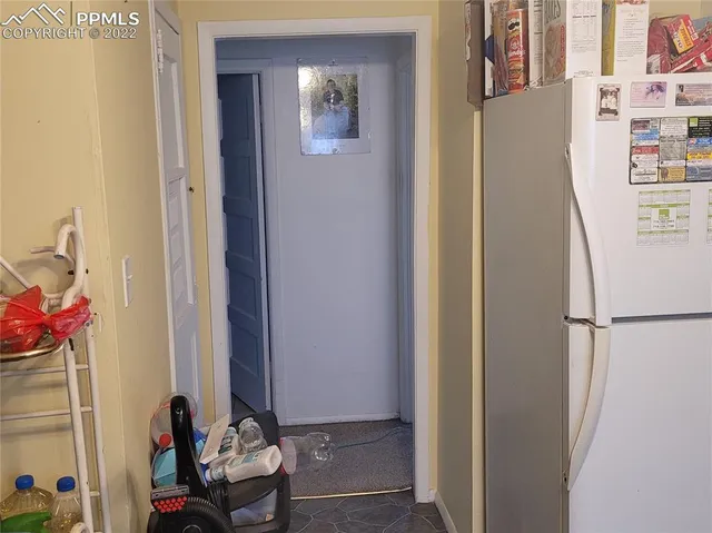 a white refrigerator freezer sitting inside of a kitchen