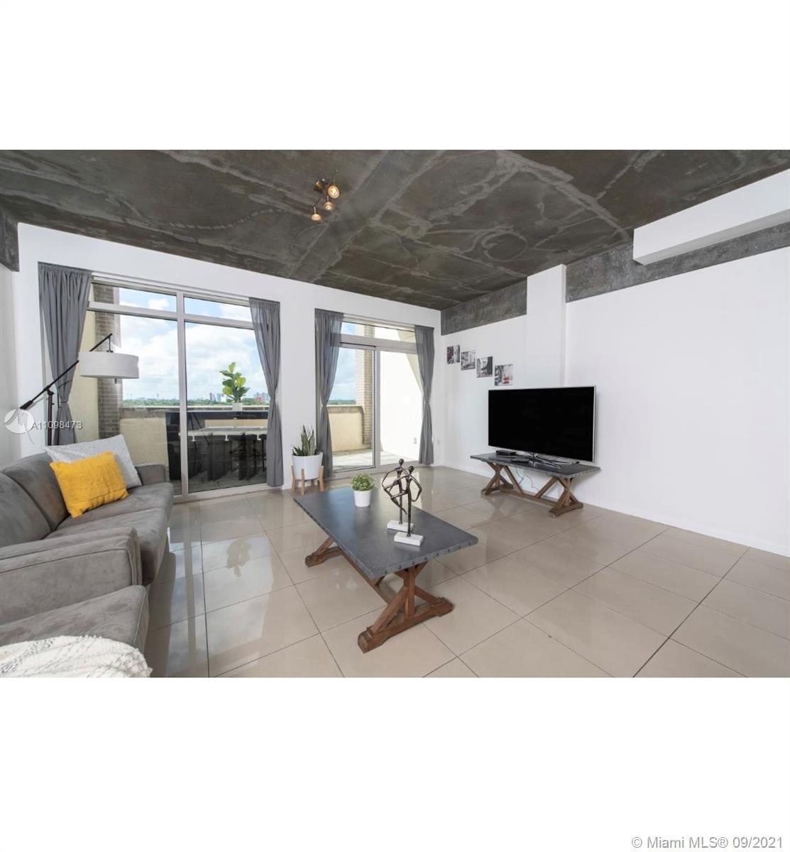 Midtown Miami Miami, FL 33127 - Photo 3 of 26 a living room with furniture and a flat screen tv