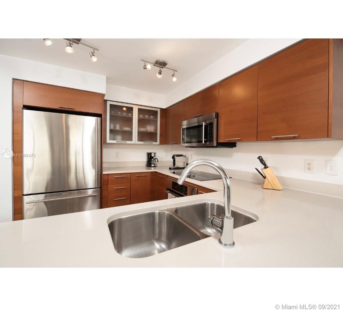Midtown Miami Miami, FL 33127 - Photo 6 of 26 a kitchen with stainless steel appliances granite countertop a sink a stove and a refrigerator