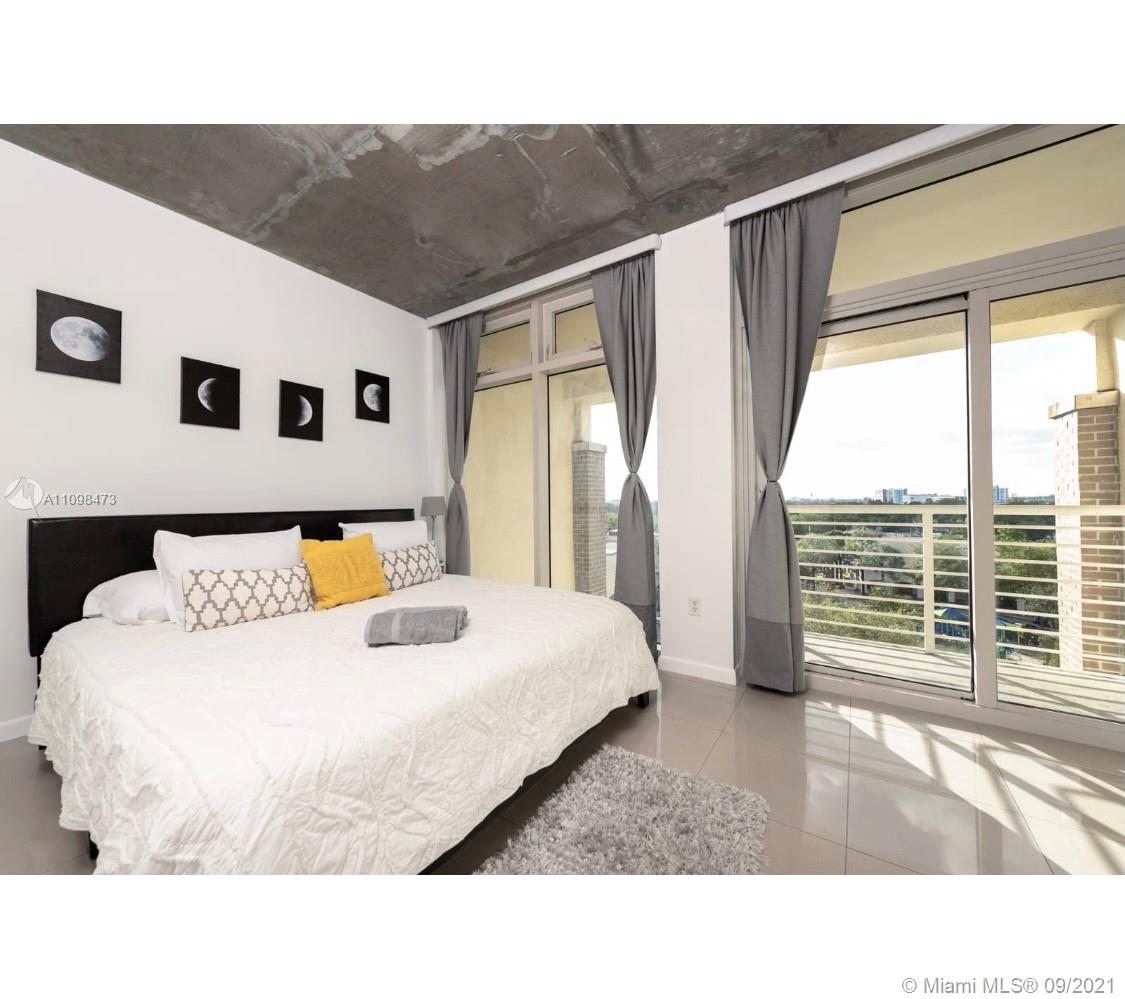 Midtown Miami Miami, FL 33127 - Photo 7 of 26 a living room with a large bed and a large window