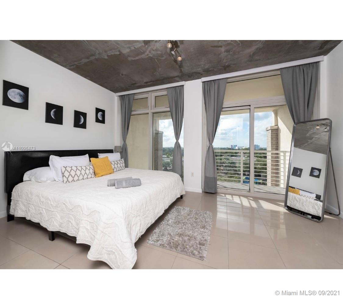 Midtown Miami Miami, FL 33127 - Photo 8 of 26 a spacious bedroom with a bed and a large window