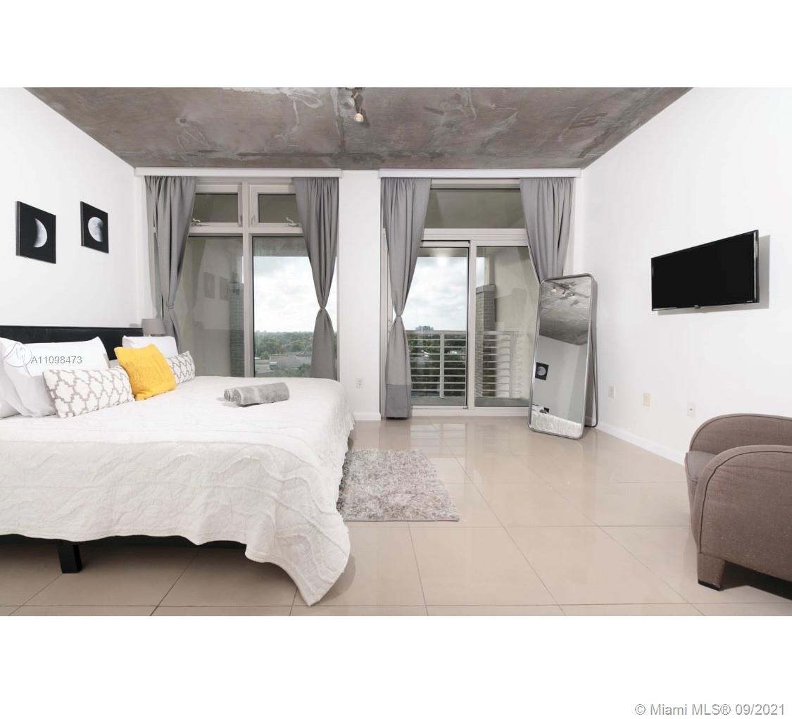 Midtown Miami Miami, FL 33127 - Photo 10 of 26 a living room with furniture and a flat screen tv