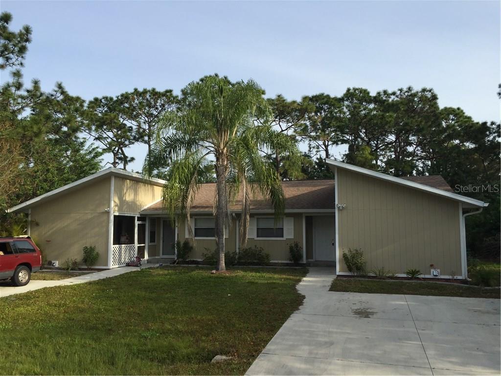 9522 Ace Road Englewood, FL 34224 - Photo 1 of 1 a front view of a house with a yard