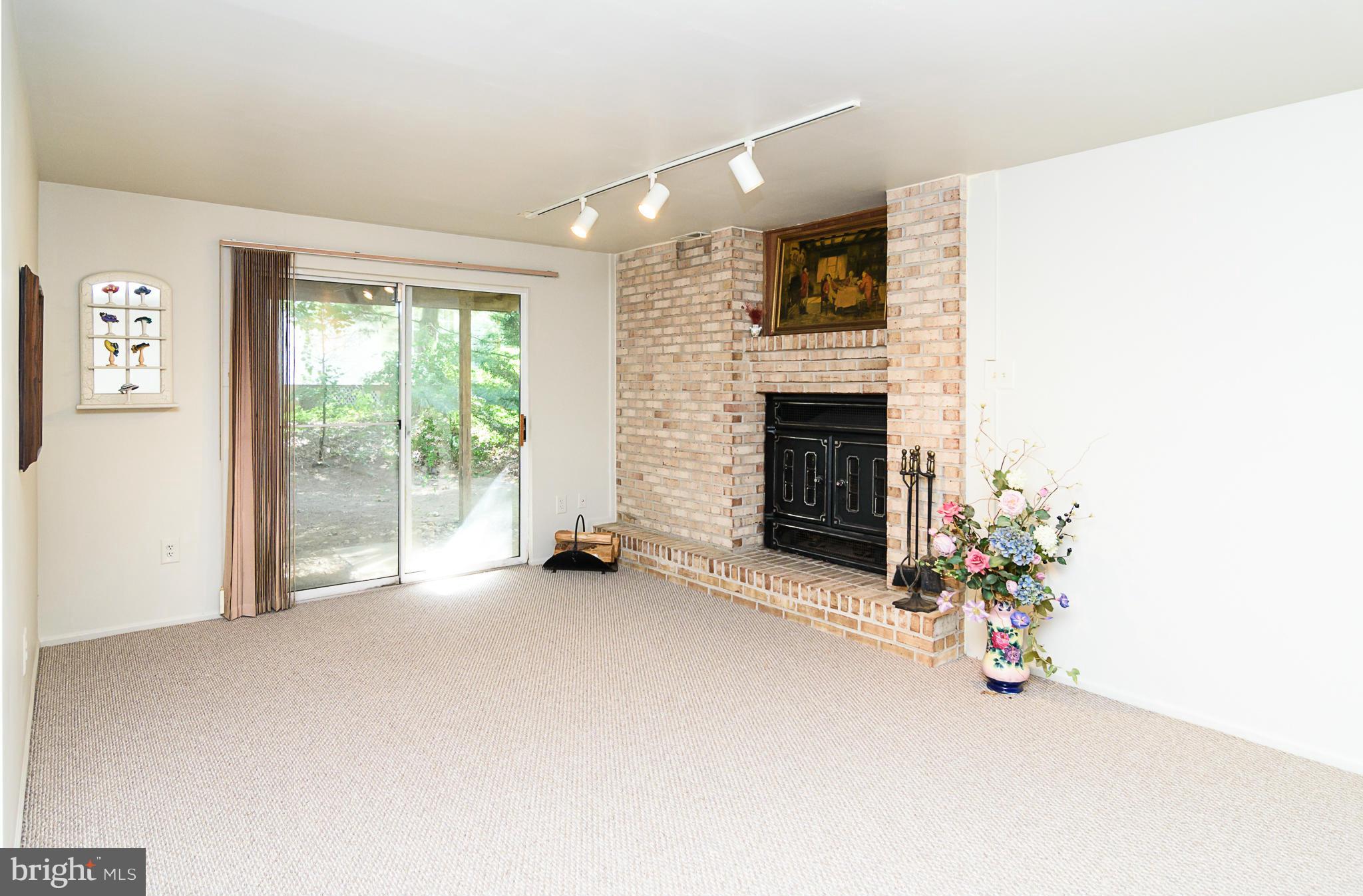 7355 Kindler Road Columbia, MD 21046 - Photo 23 of 30 Wood-burning fireplace with brick hearth