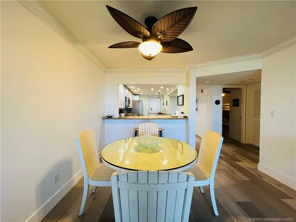 a view of a dining room with furniture and a mirror