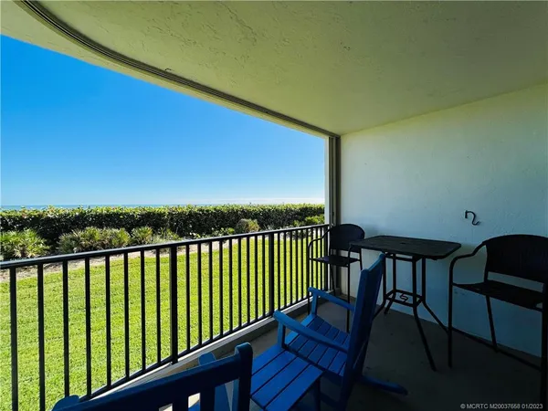 a view of a balcony with an outdoor seating