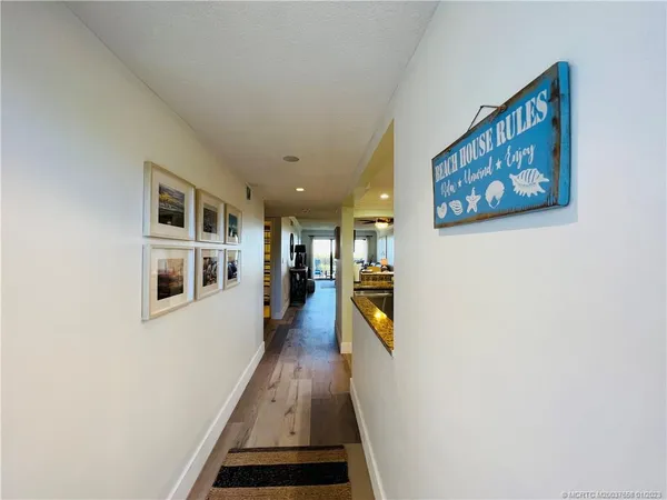 a hallway with wooden floor and a workspace