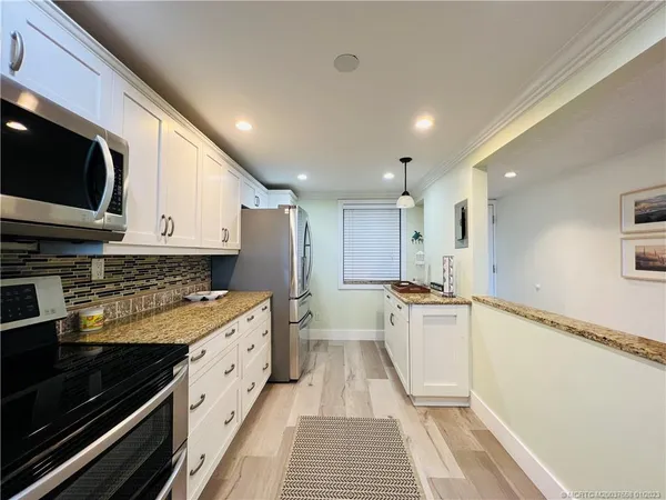 a large kitchen with a stove and a sink