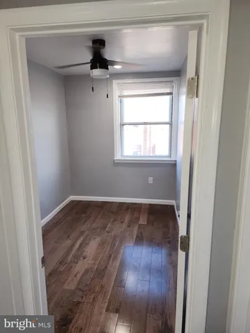 a view of a small space with wooden floor and a window