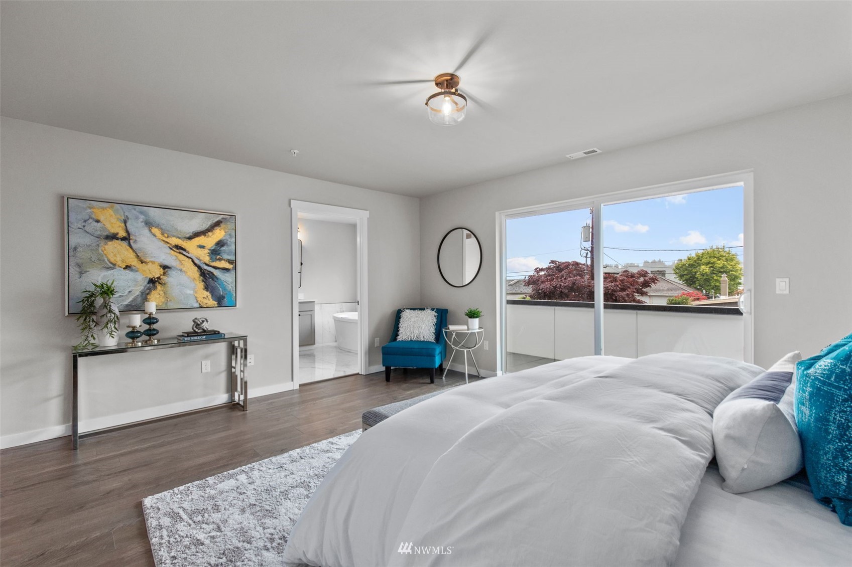 714 Stitch Road Lake Stevens, WA 98258 - Photo 25 of 40 a bedroom with a large bed and a chandelier